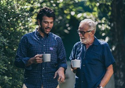 A senior father talking to his son