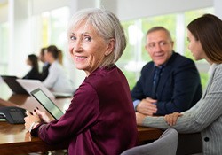 A senior businesswoman working in a conference room