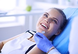 patient smiling while talking to dentist