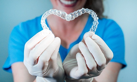 dentist making heart with two clear aligners 
